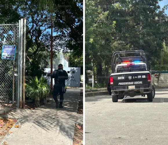 A police officer walking towards a gate and a police truck parked with flashing lights